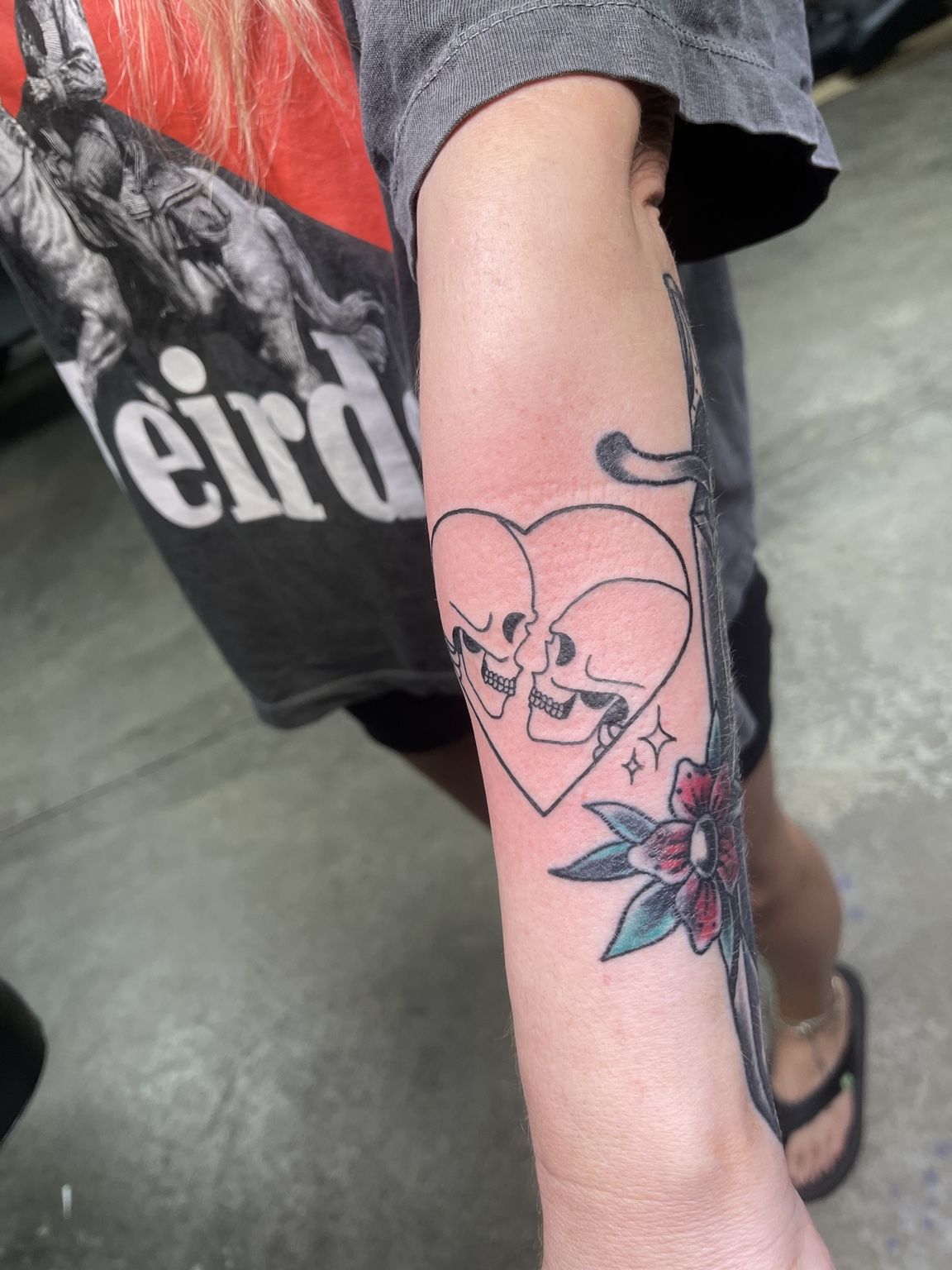 Heart and skull forearm tattoo, view one