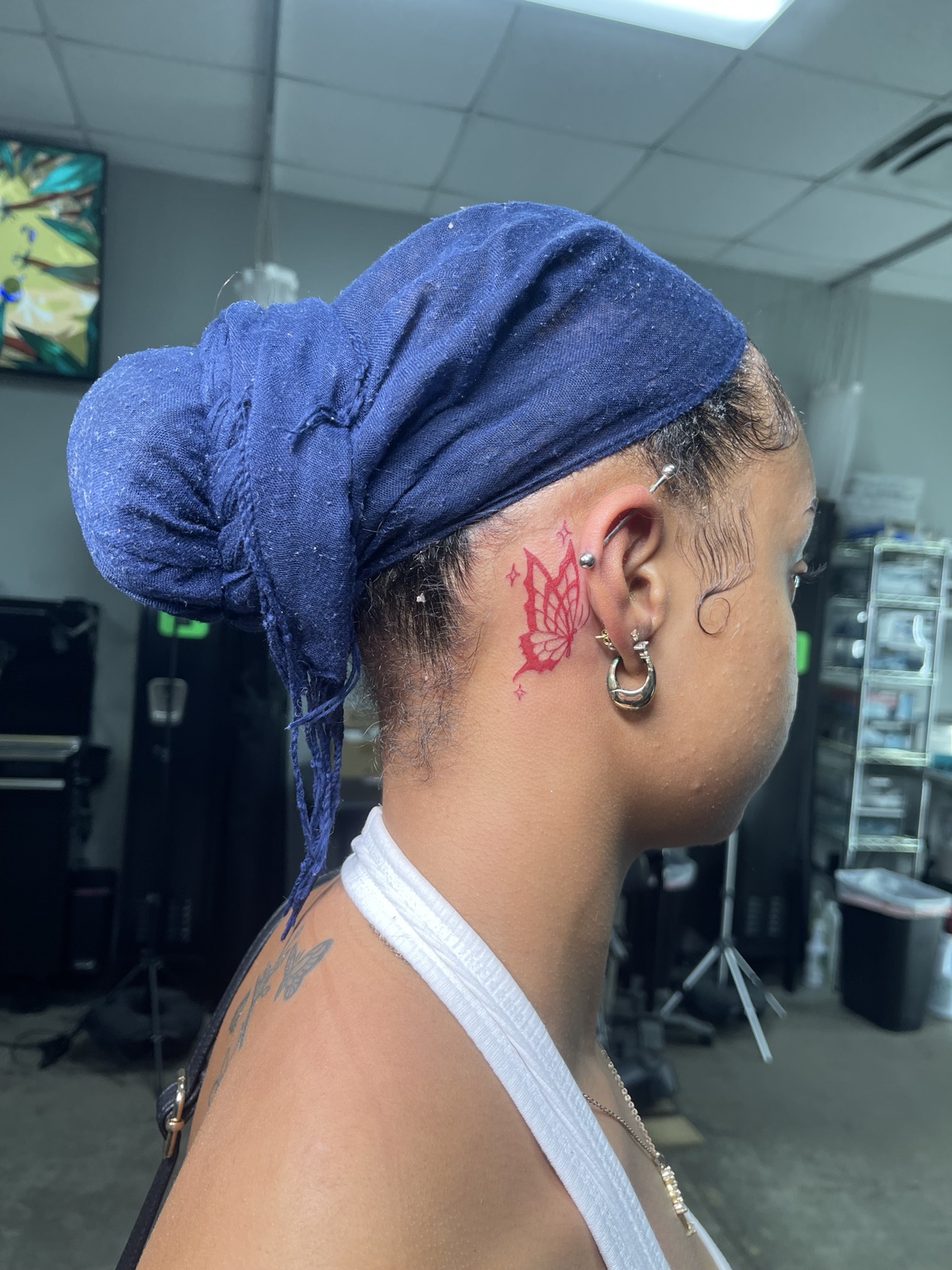 Small red line tattoo behind the ear