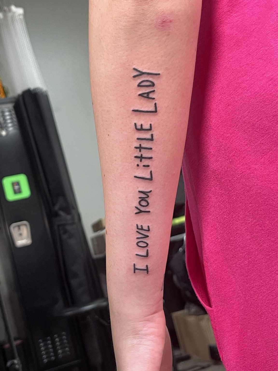 Vertical script tattoo reading I love you little lady