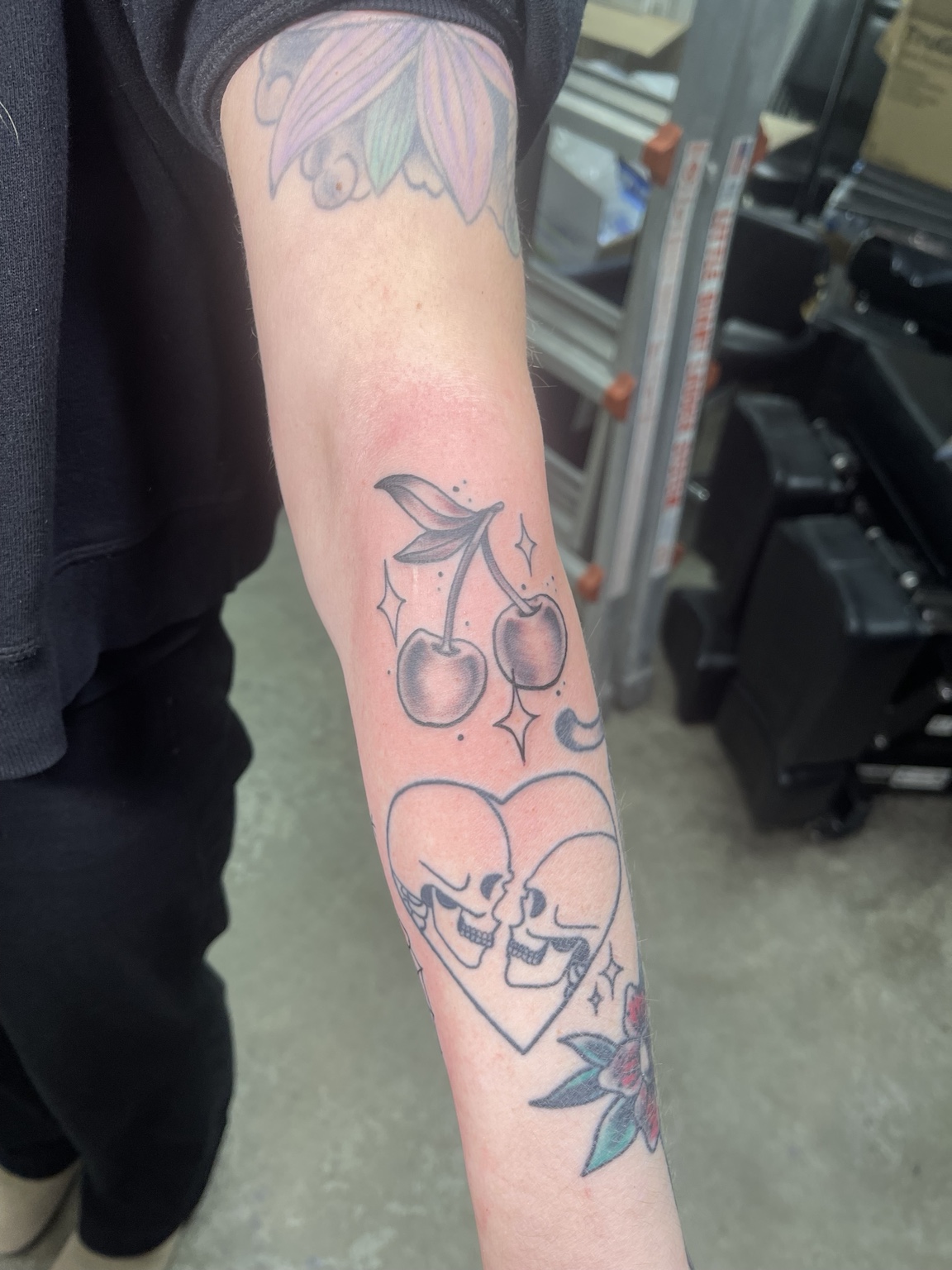 Cherries and skull heart tattoo