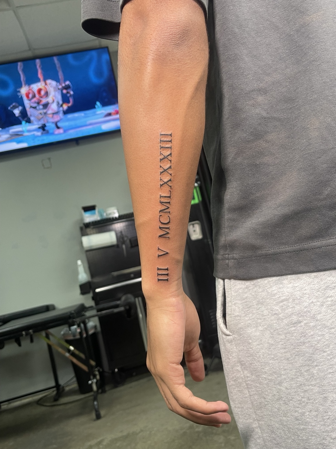 Roman numeral forearm tattoo