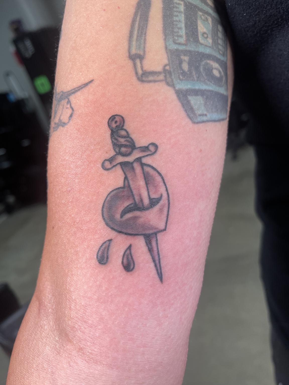 Small dagger tattoo with drops