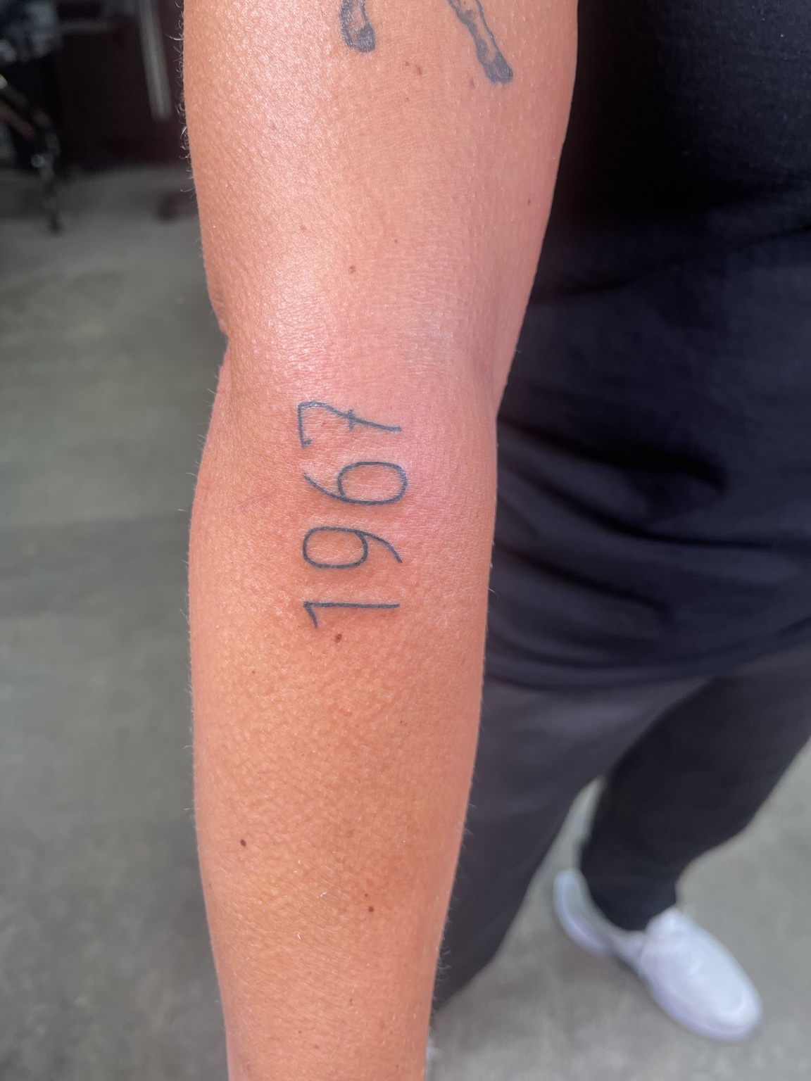 Simple year tattoo on forearm
