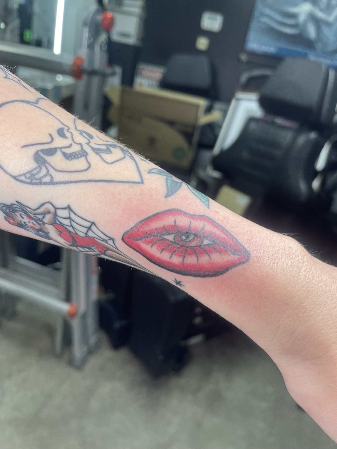 Color eye and lips forearm tattoo