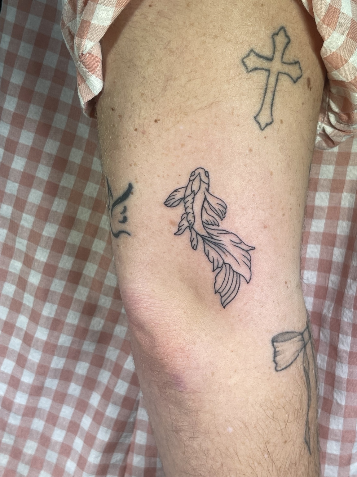 Fish and cross linework tattoo