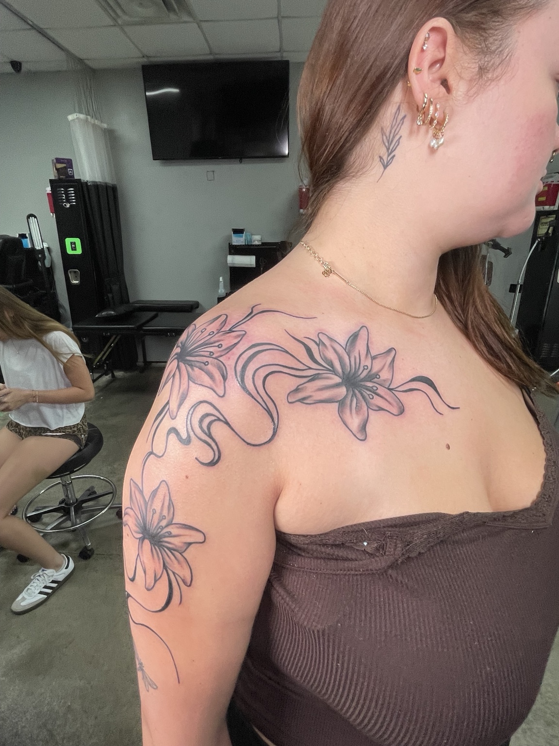 Floral shoulder tattoo detail view