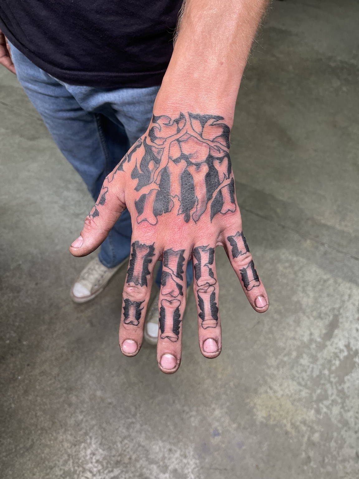 Completed black skeleton hand tattoo