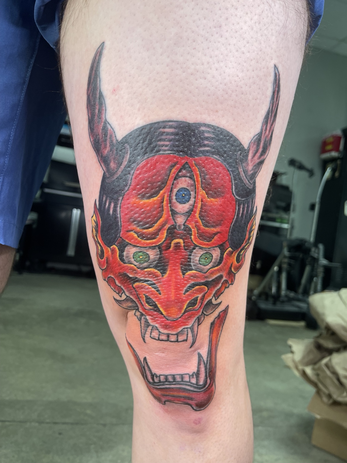 Completed color Oni mask leg tattoo
