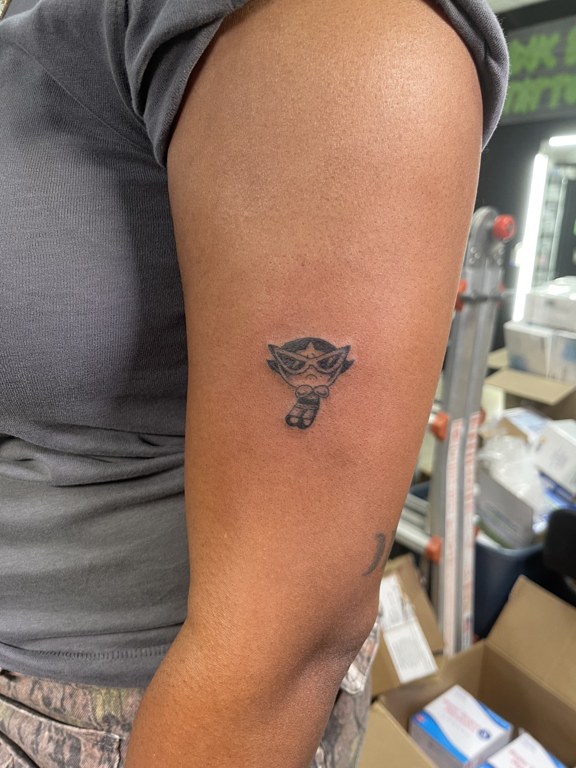 Small rose tattoo on upper arm