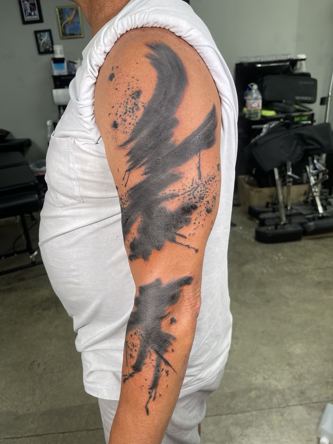Completed abstract brushwork arm tattoo