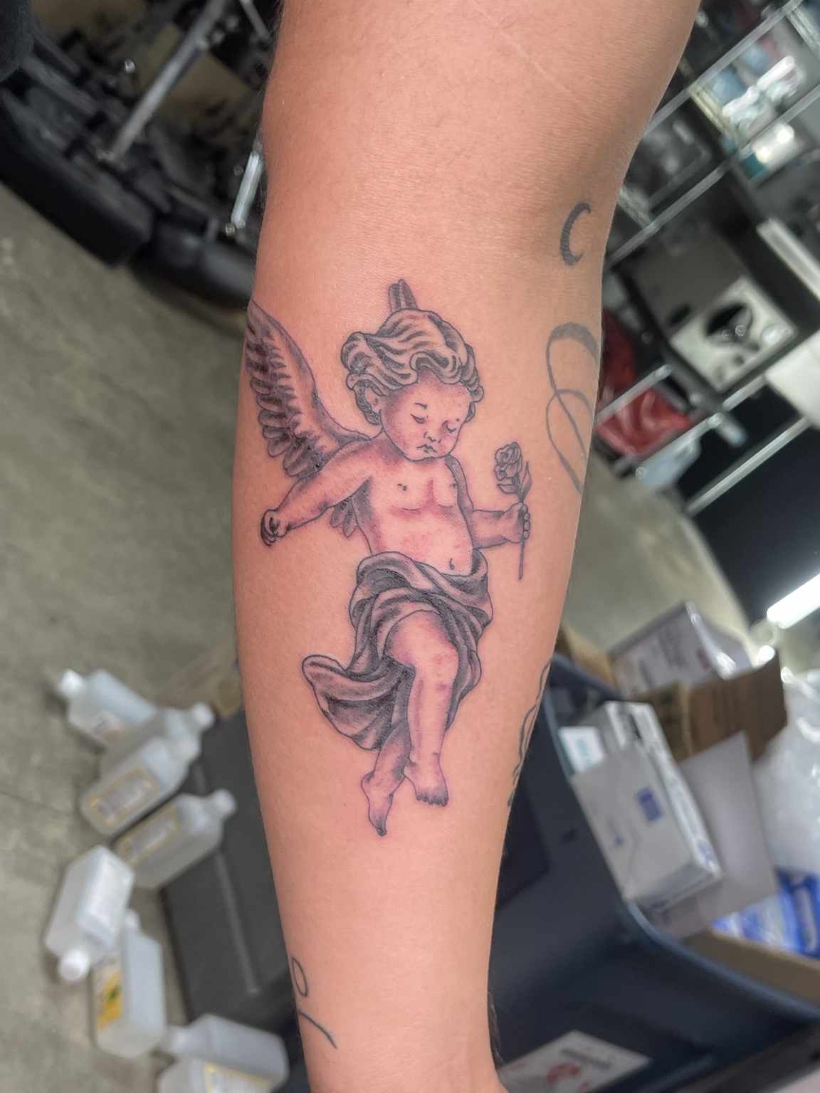 Small black and grey angel tattoo