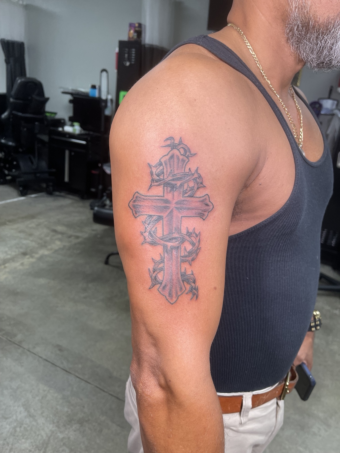 Layered cross upper arm tattoo
