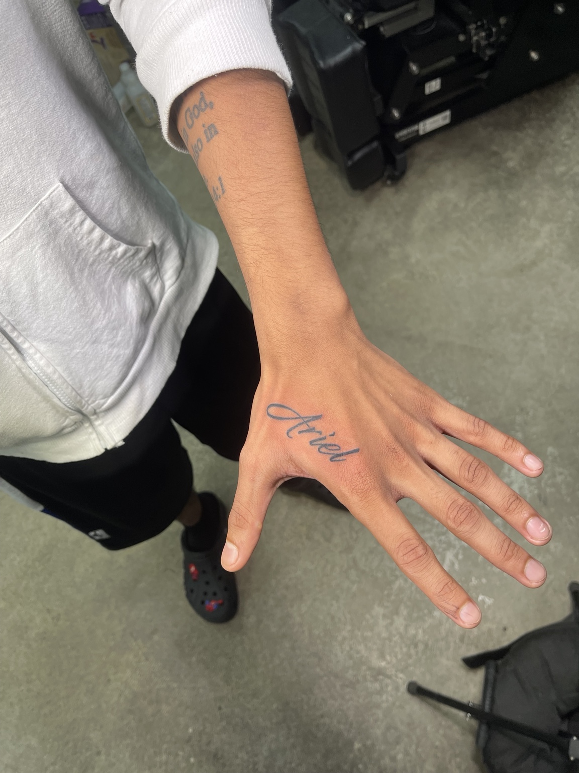 Small script tattoo across the hand