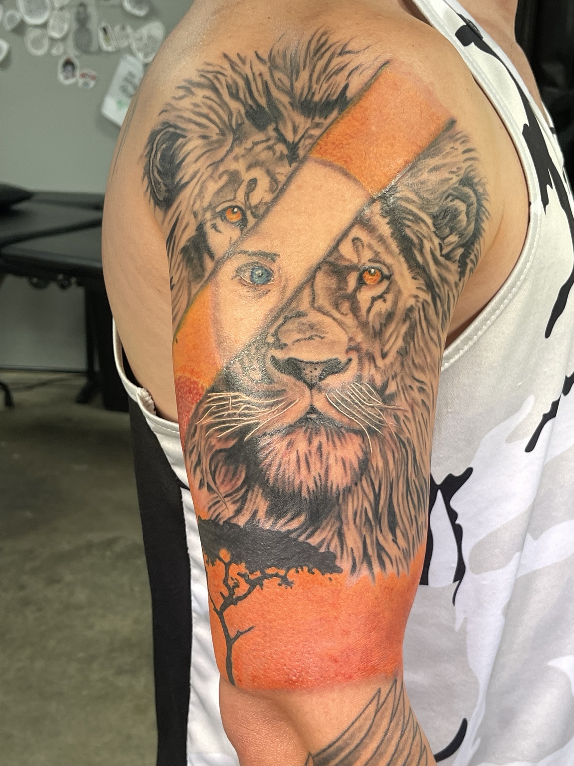 Lion upper arm tattoo