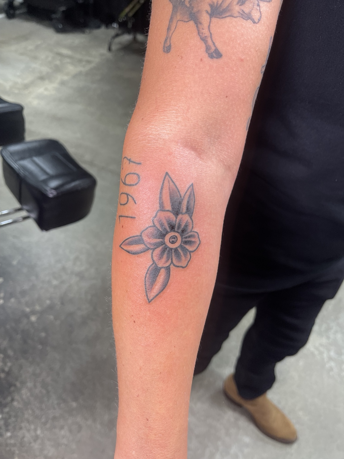 Small floral forearm tattoo