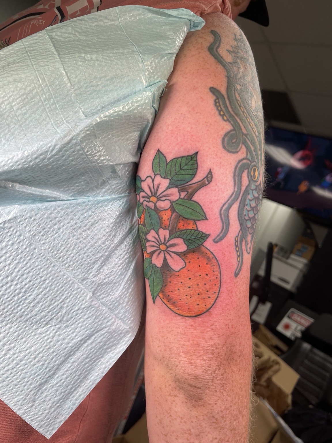 Red floral upper arm tattoo second view
