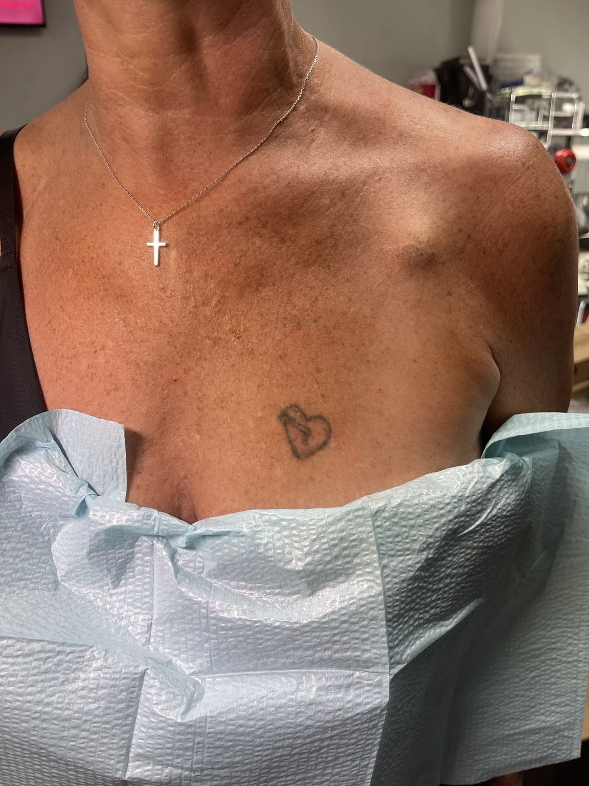 Small chest symbol tattoo