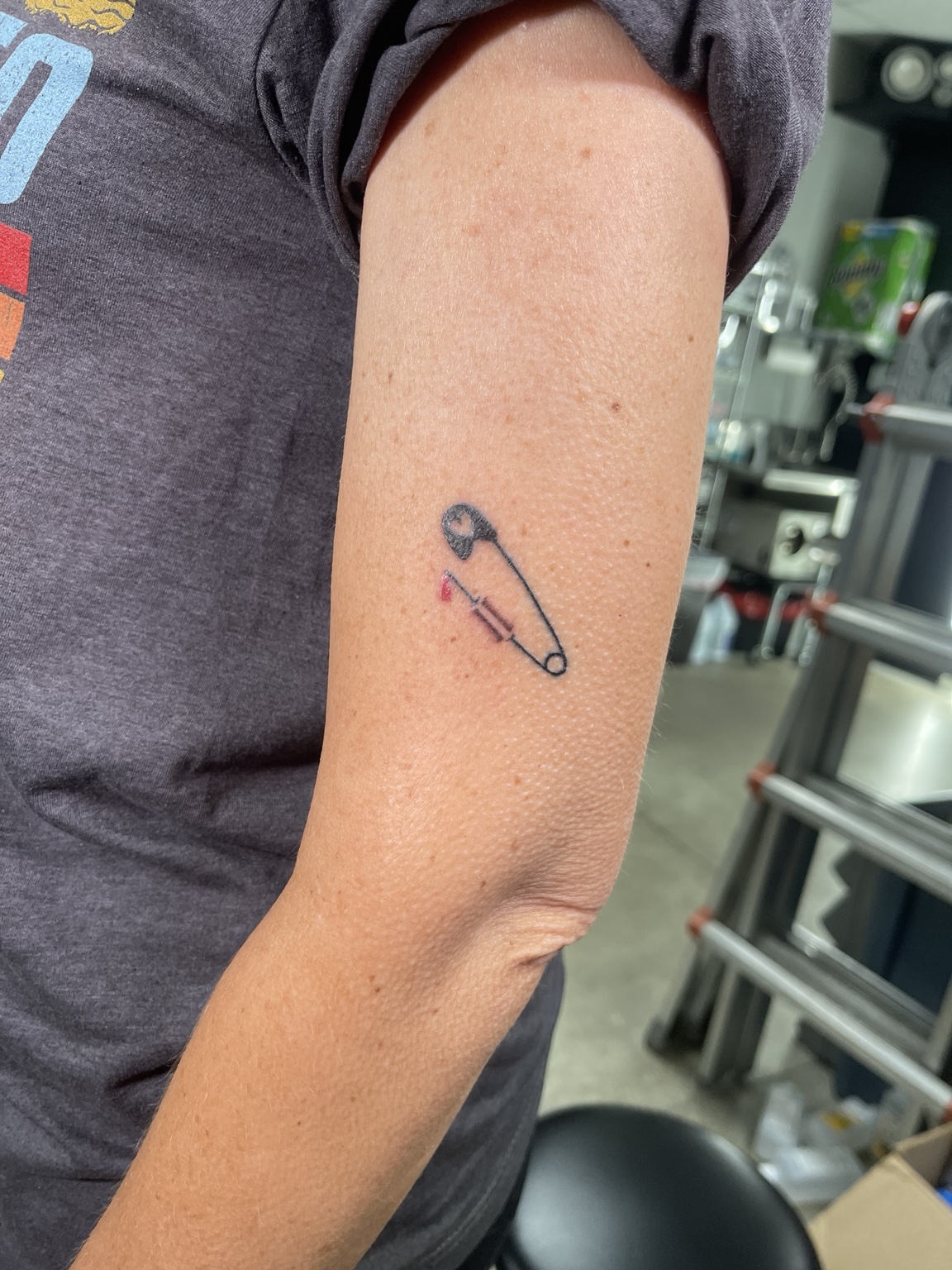 Small safety pin tattoo