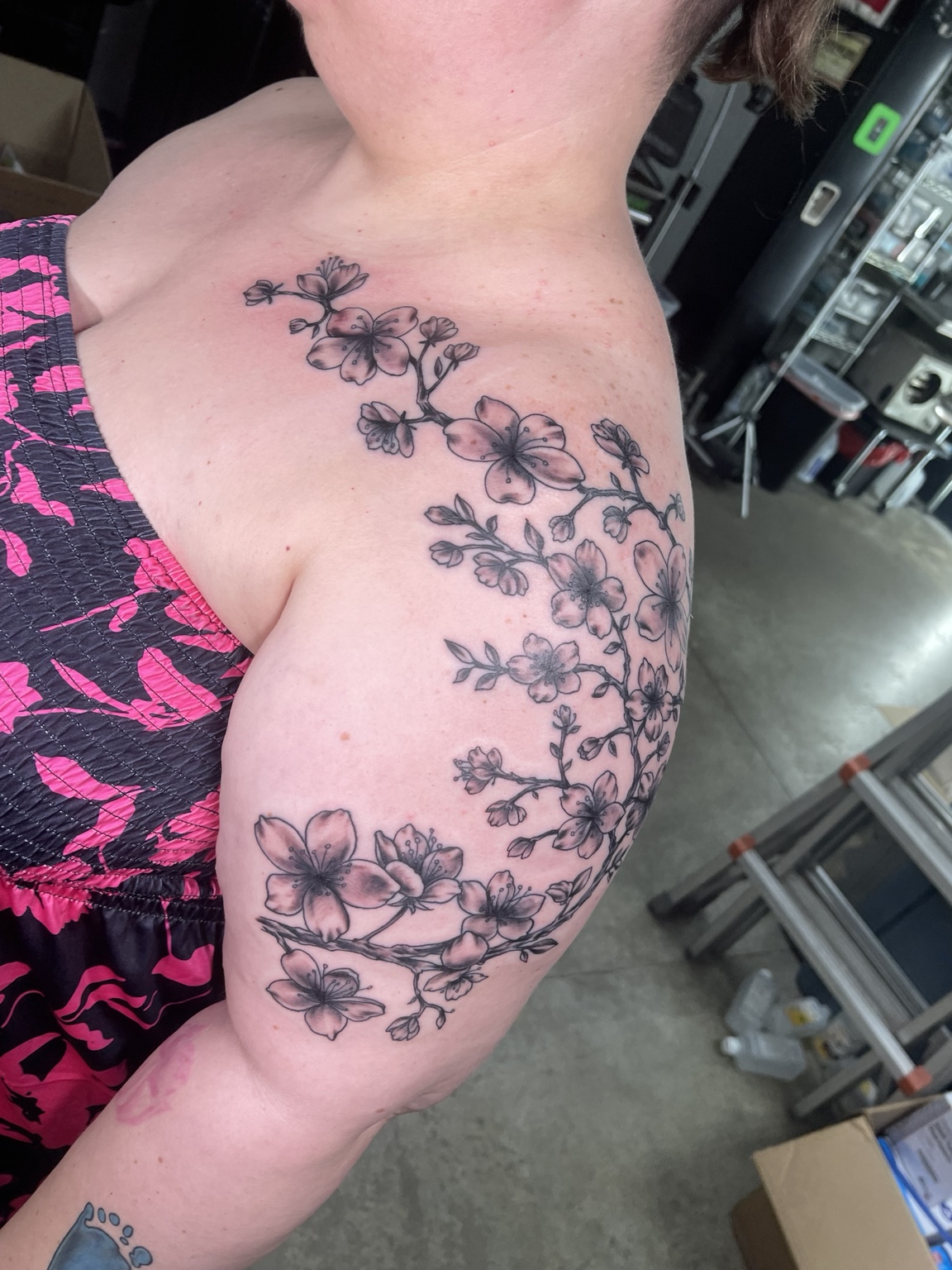 Black floral chest and shoulder tattoo