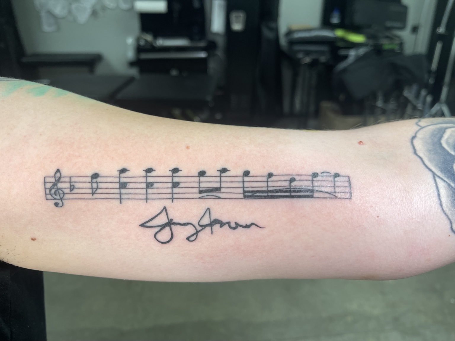 Music staff tattoo