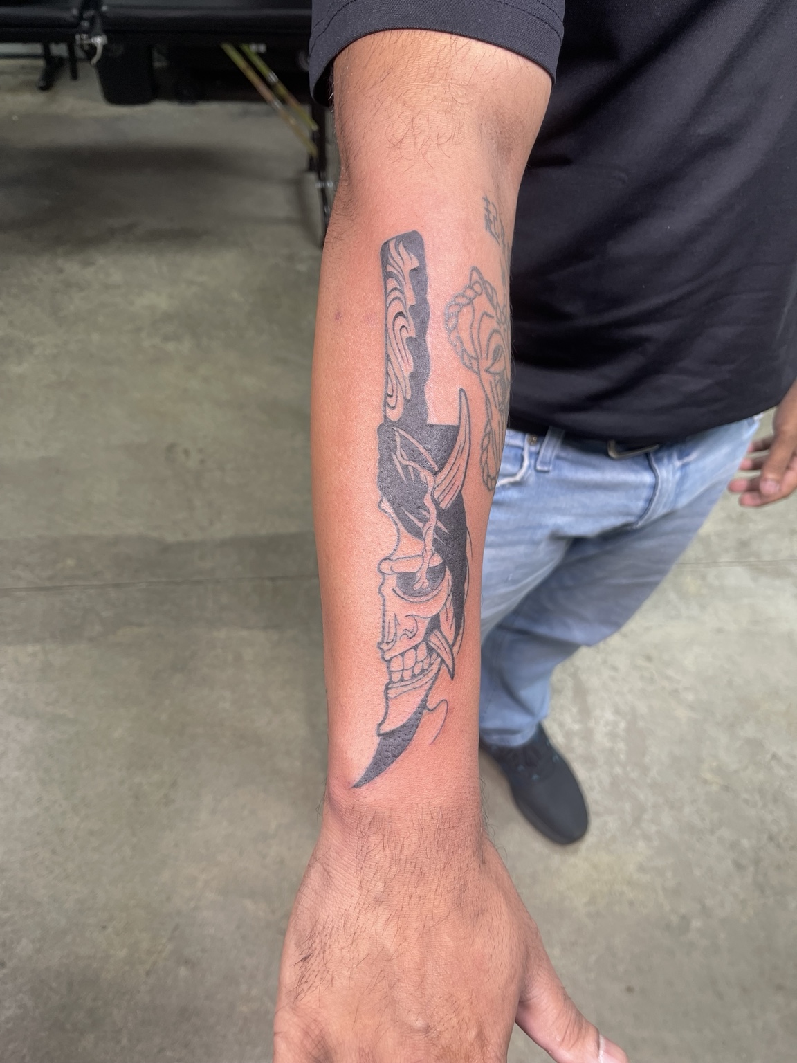 Figure forearm tattoo