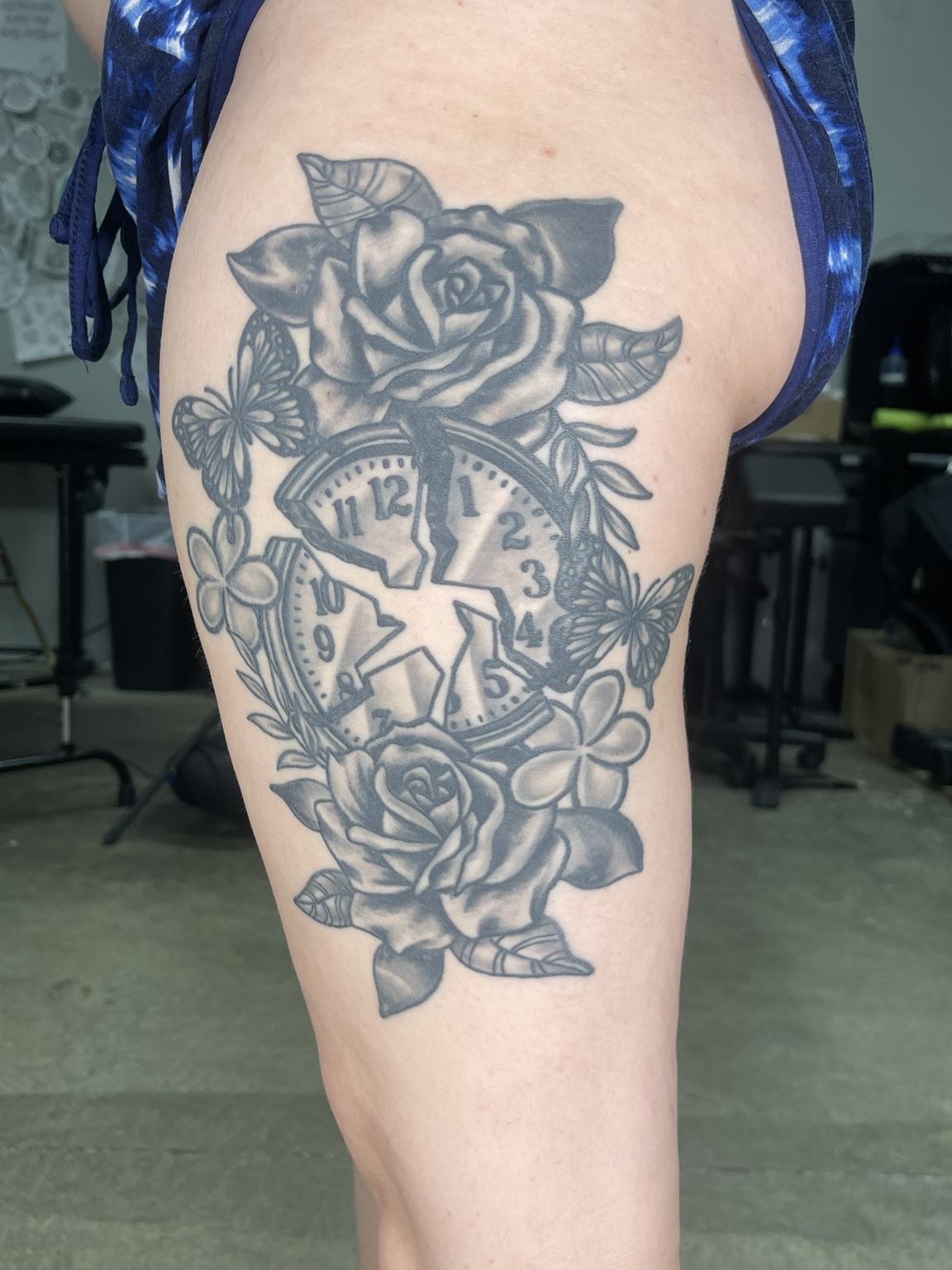 Black and grey rose thigh tattoo