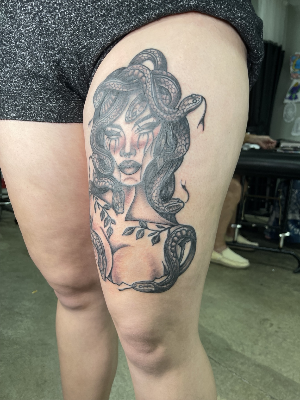 Woman thigh tattoo alternate view