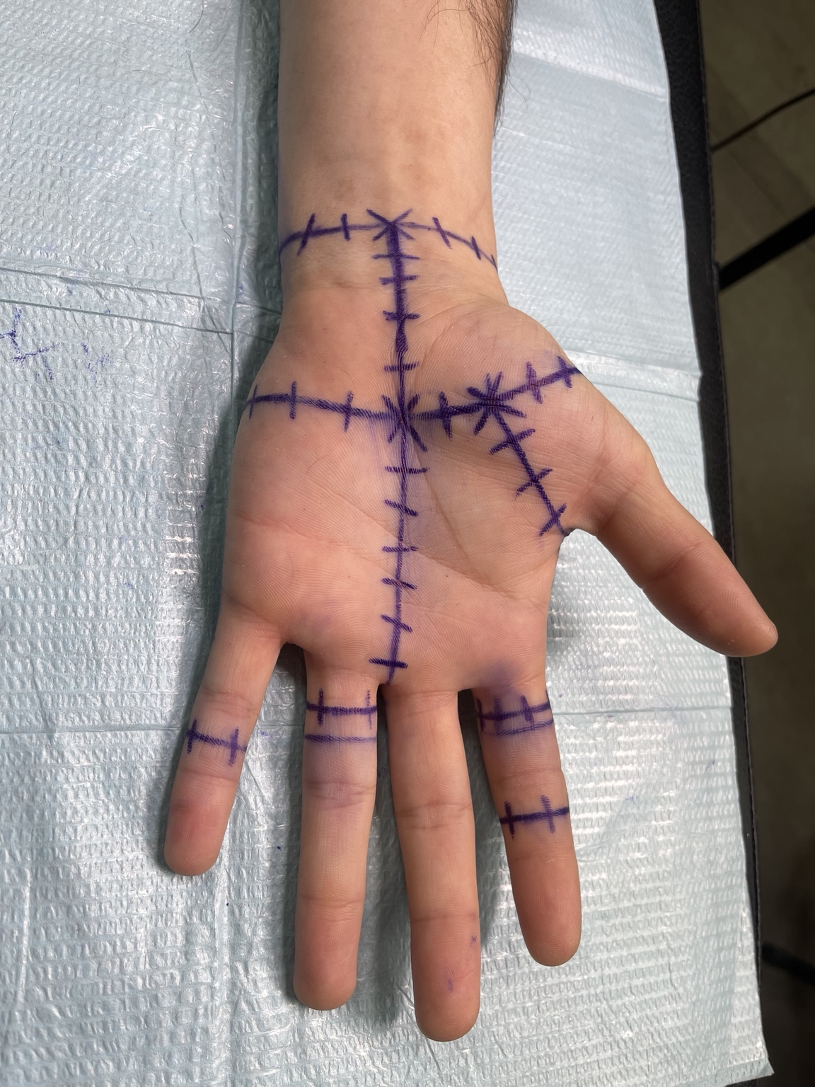 Stitched line hand tattoo view one