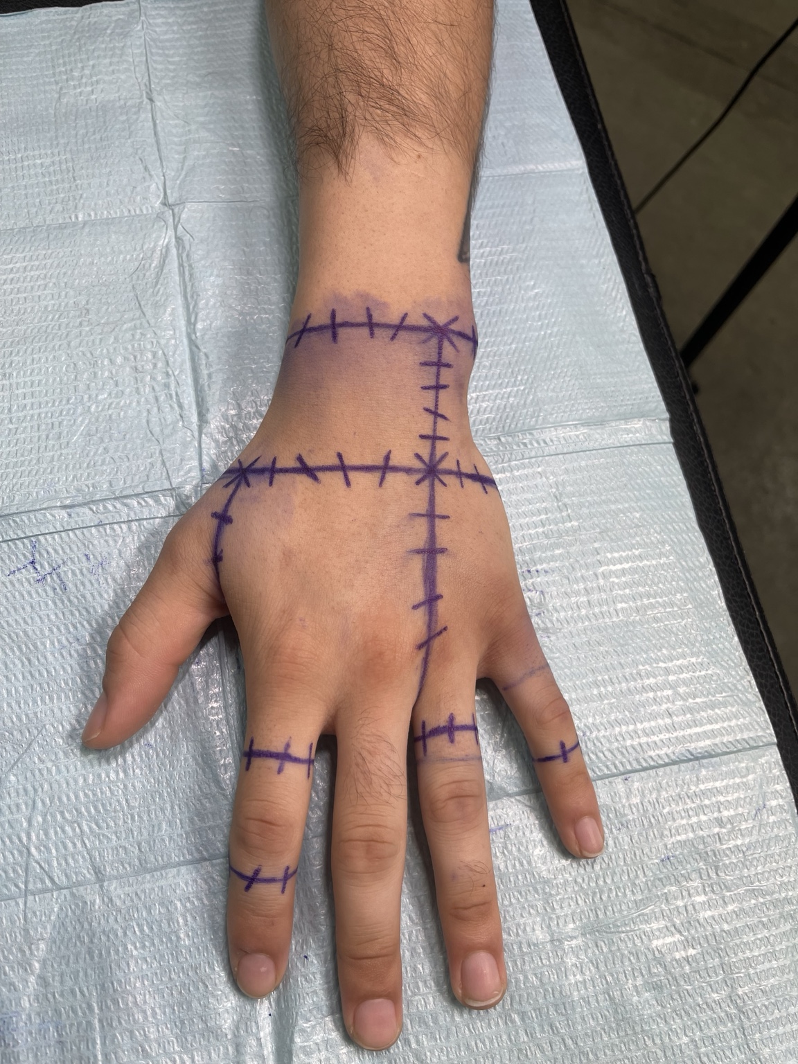 Stitched line hand tattoo view two