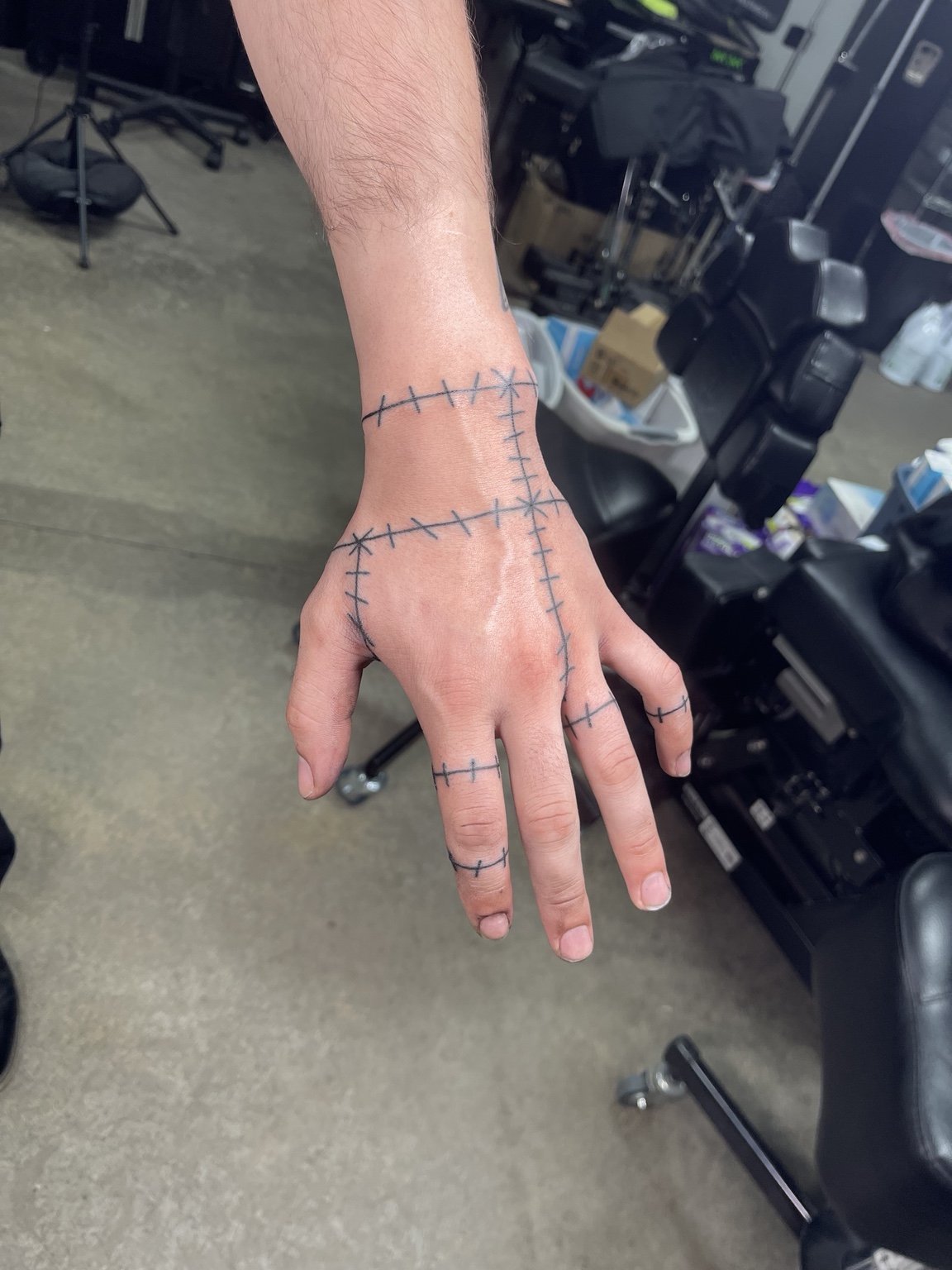 Stitched line hand tattoo view four