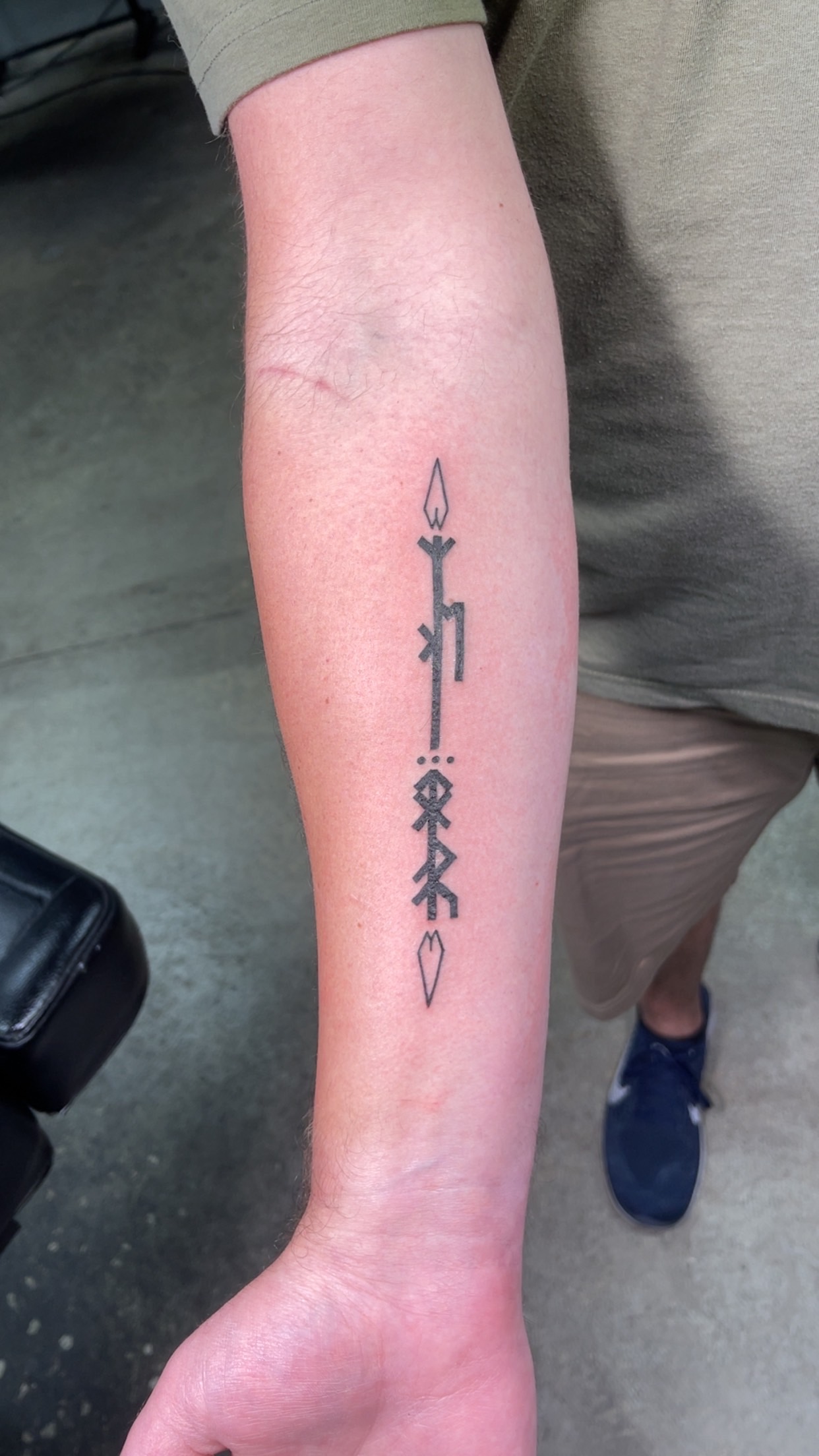 Vertical forearm script tattoo