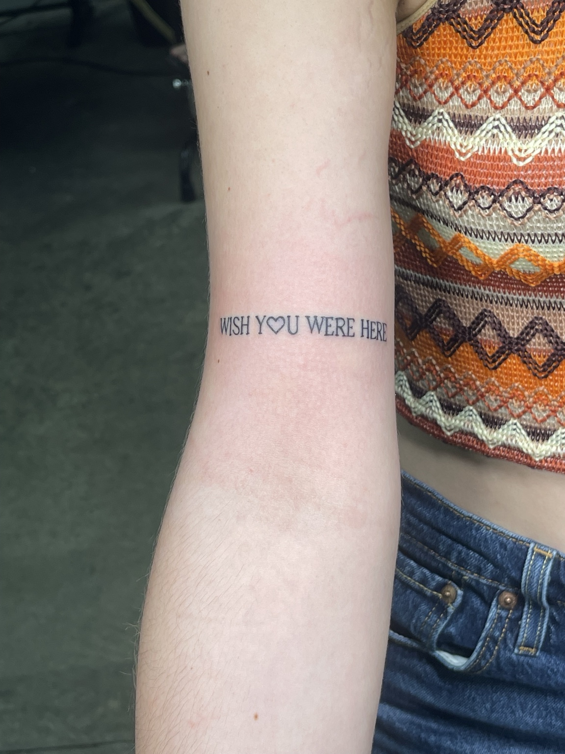 Small text forearm tattoo