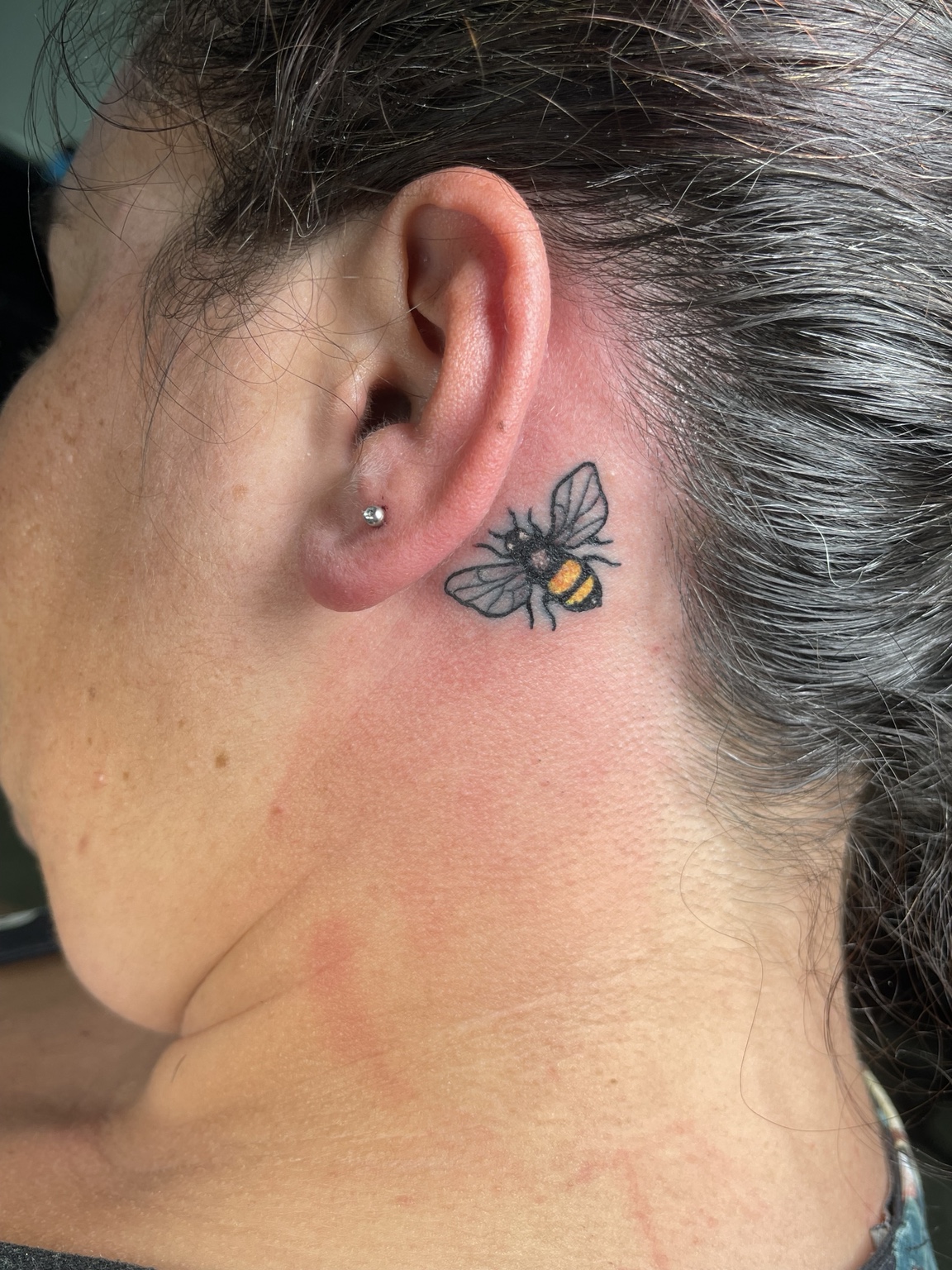 Small butterfly behind ear tattoo