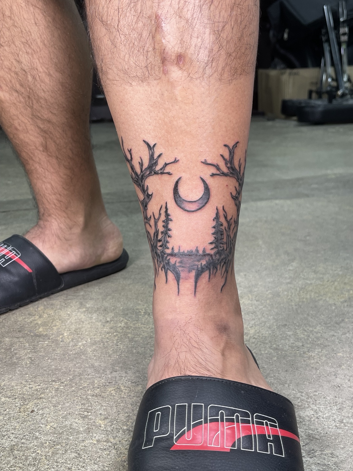 Branch style lower leg tattoo front view