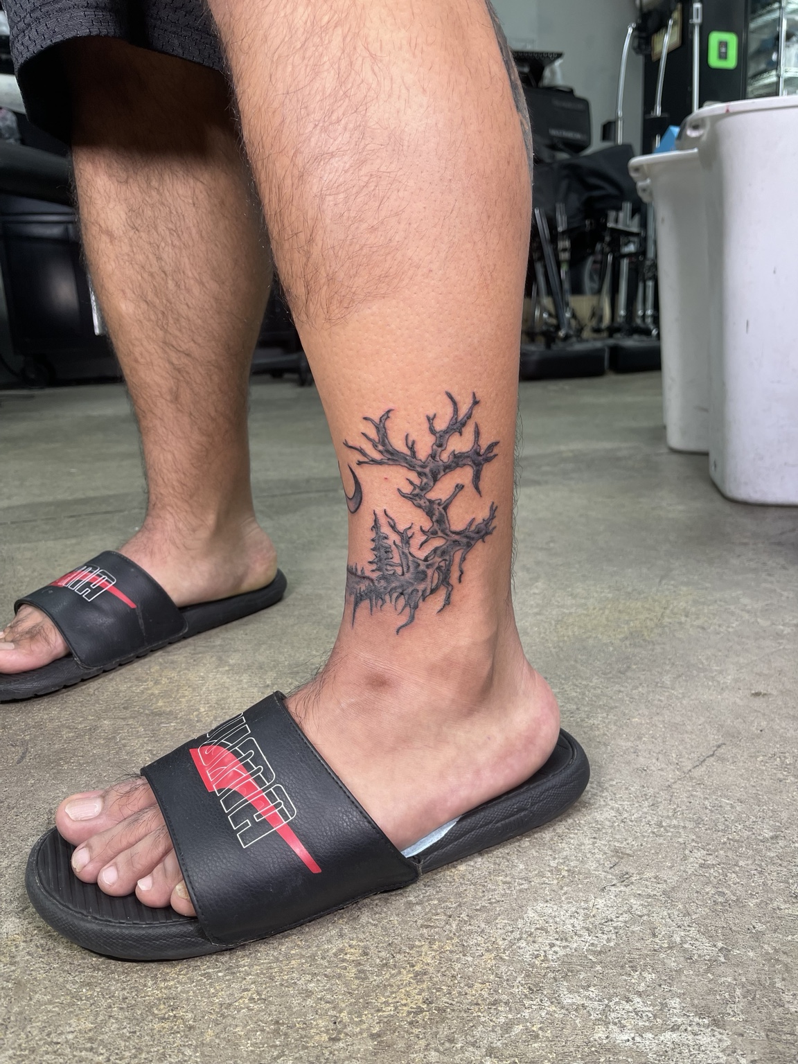 Branch style lower leg tattoo side view