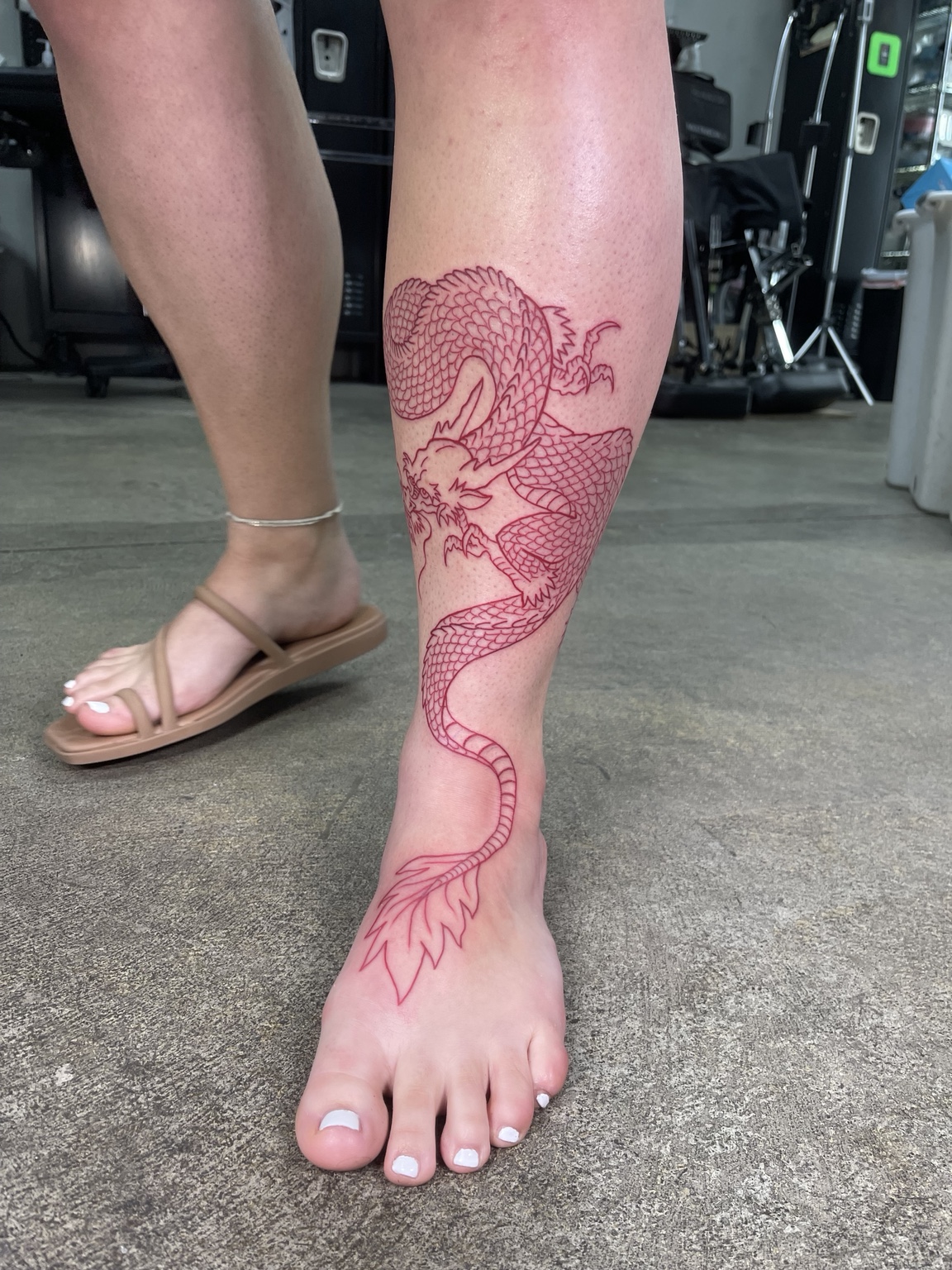 Red outline leg tattoo process view two