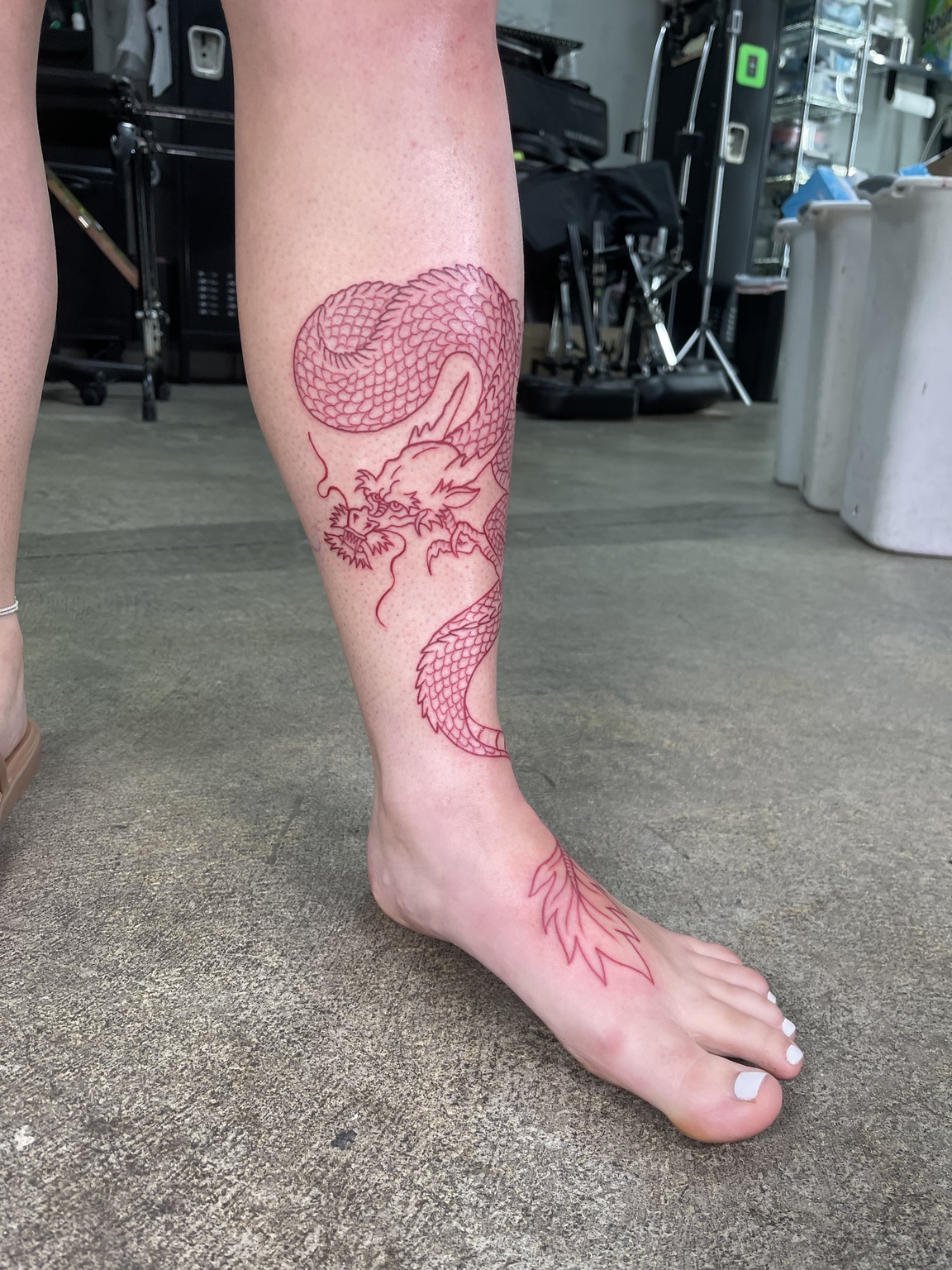 Red outline leg tattoo process view one