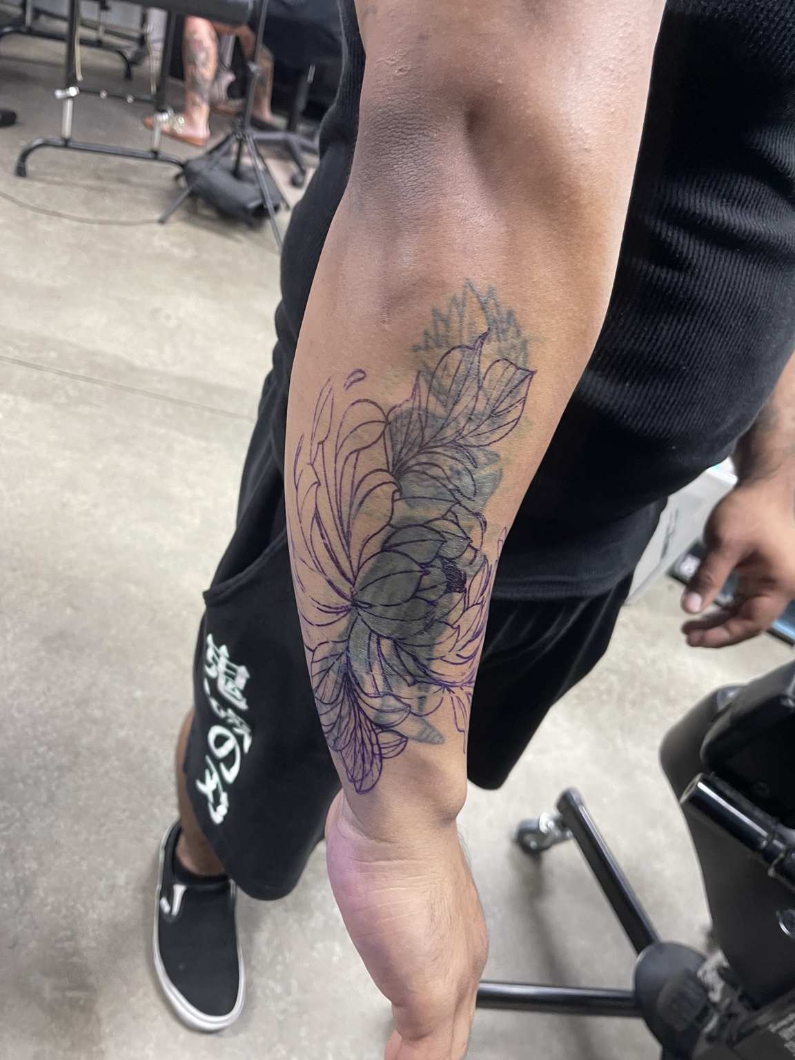 Floral forearm tattoo side view
