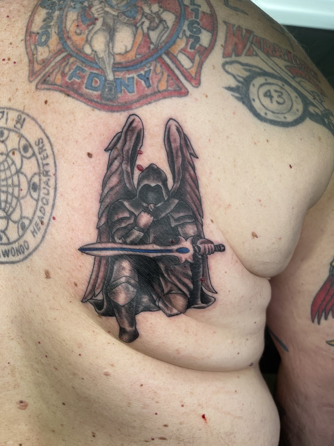 Dark character chest tattoo