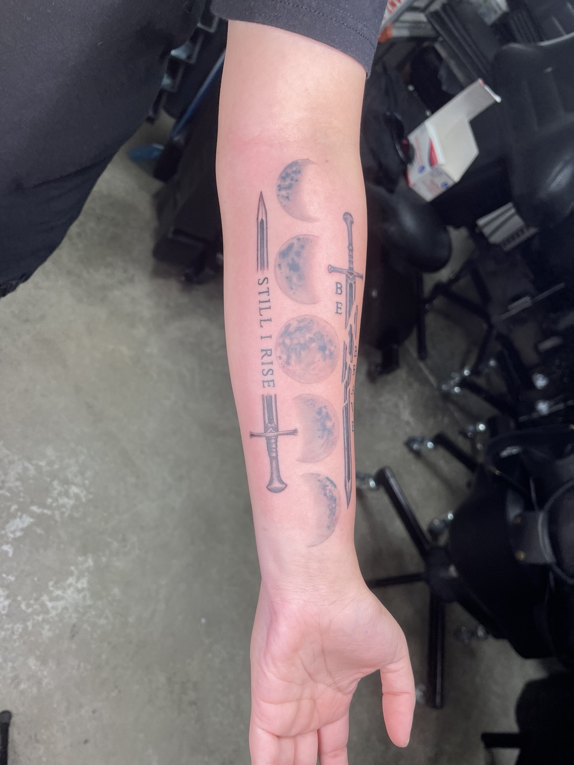 Sword and feather forearm tattoo alternate view