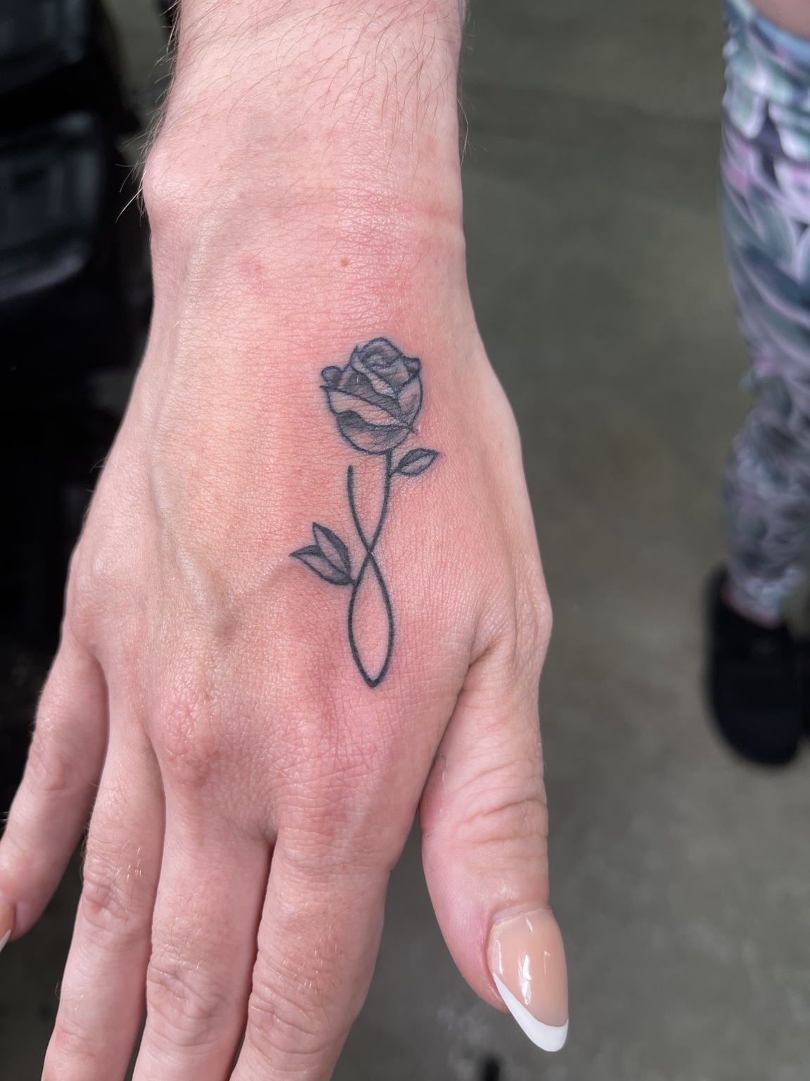 Small rose hand tattoo