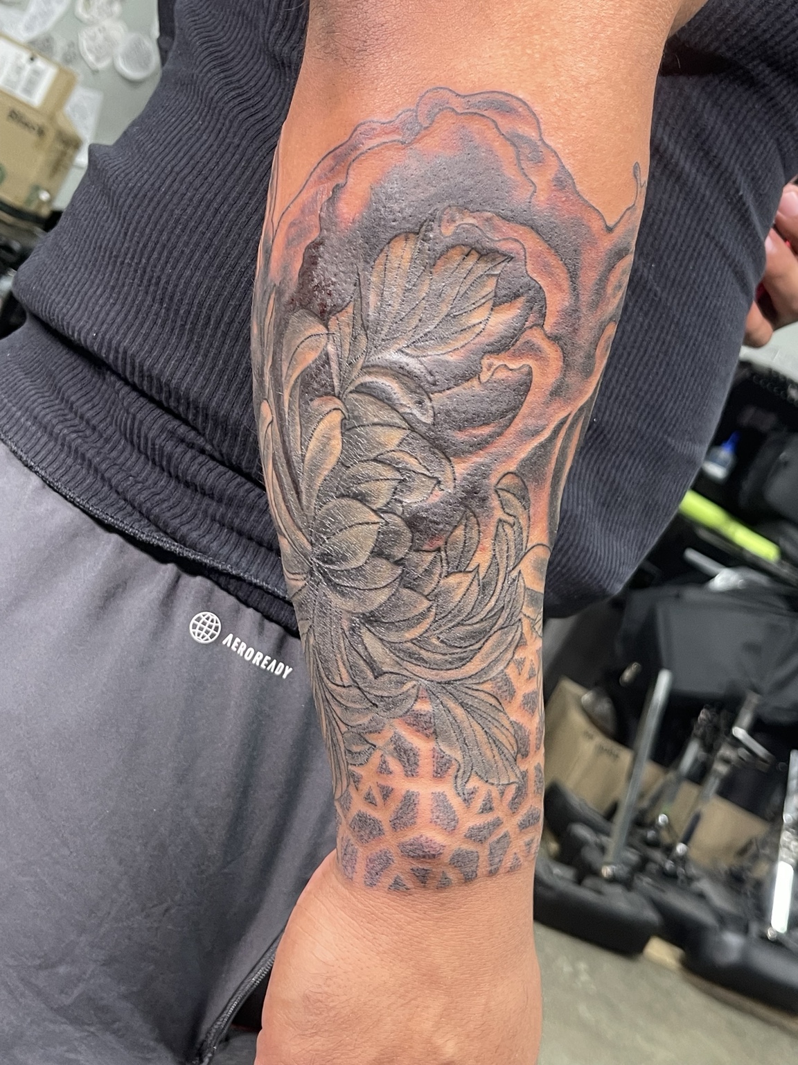 Black and grey peony forearm tattoo alternate view