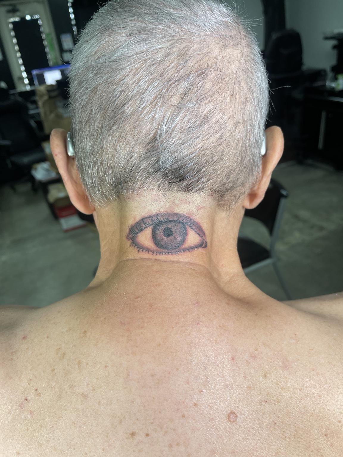 Eye tattoo at back of neck