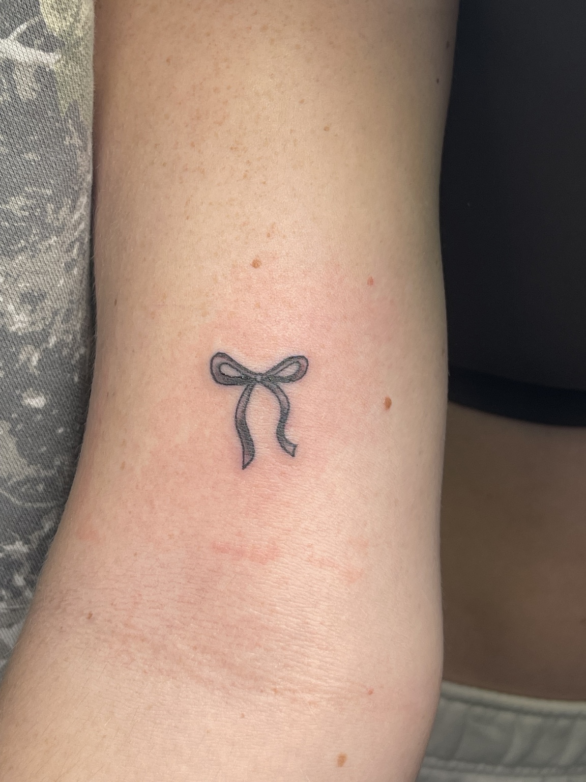 Small bow tattoo