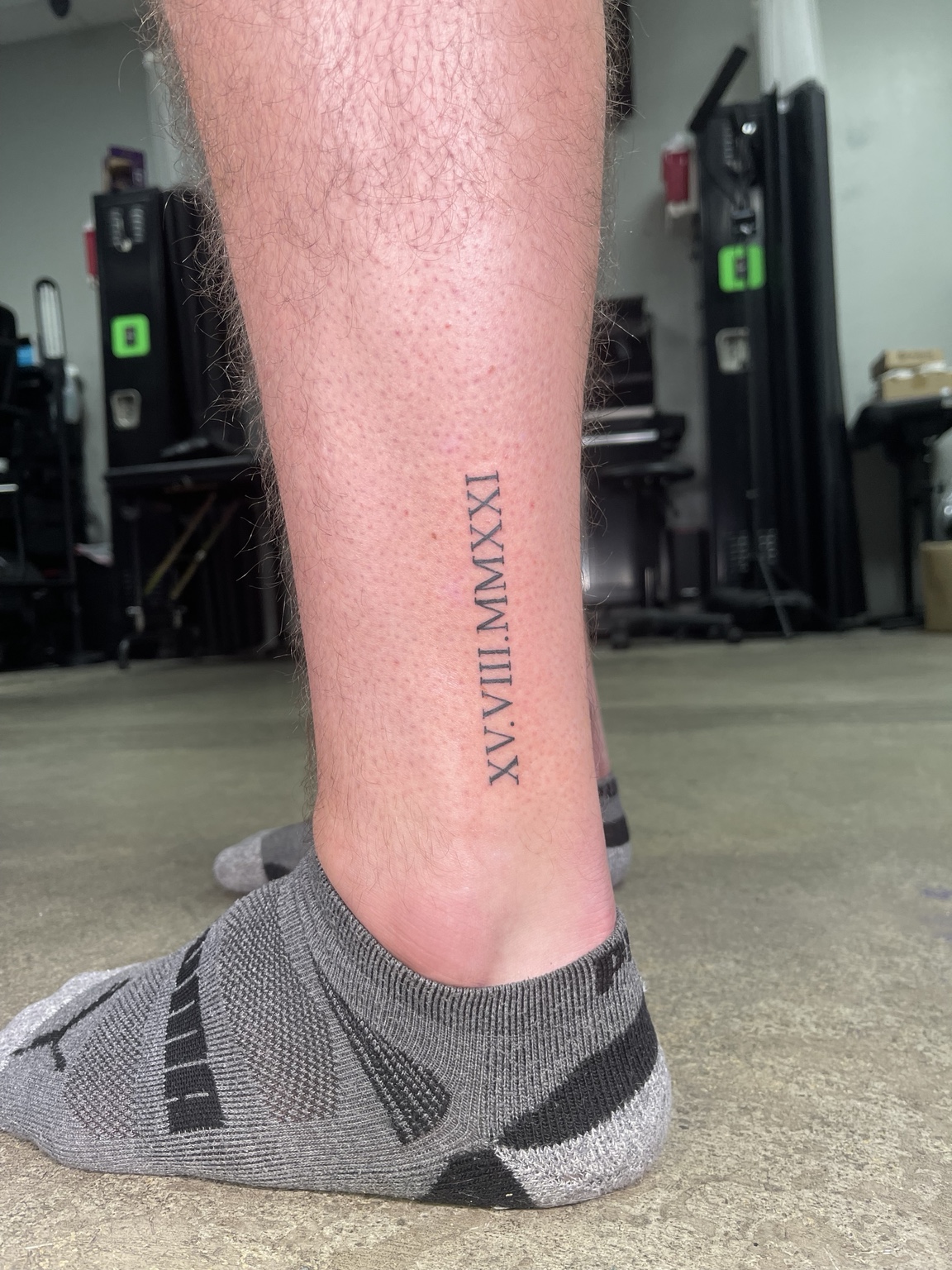 Vertical lettering leg tattoo