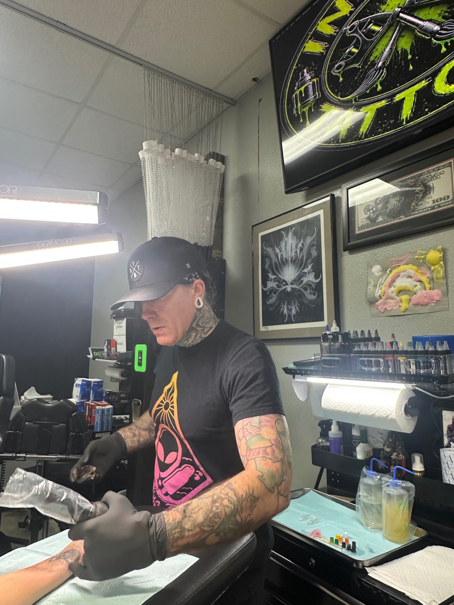 Paulie working at his tattoo station