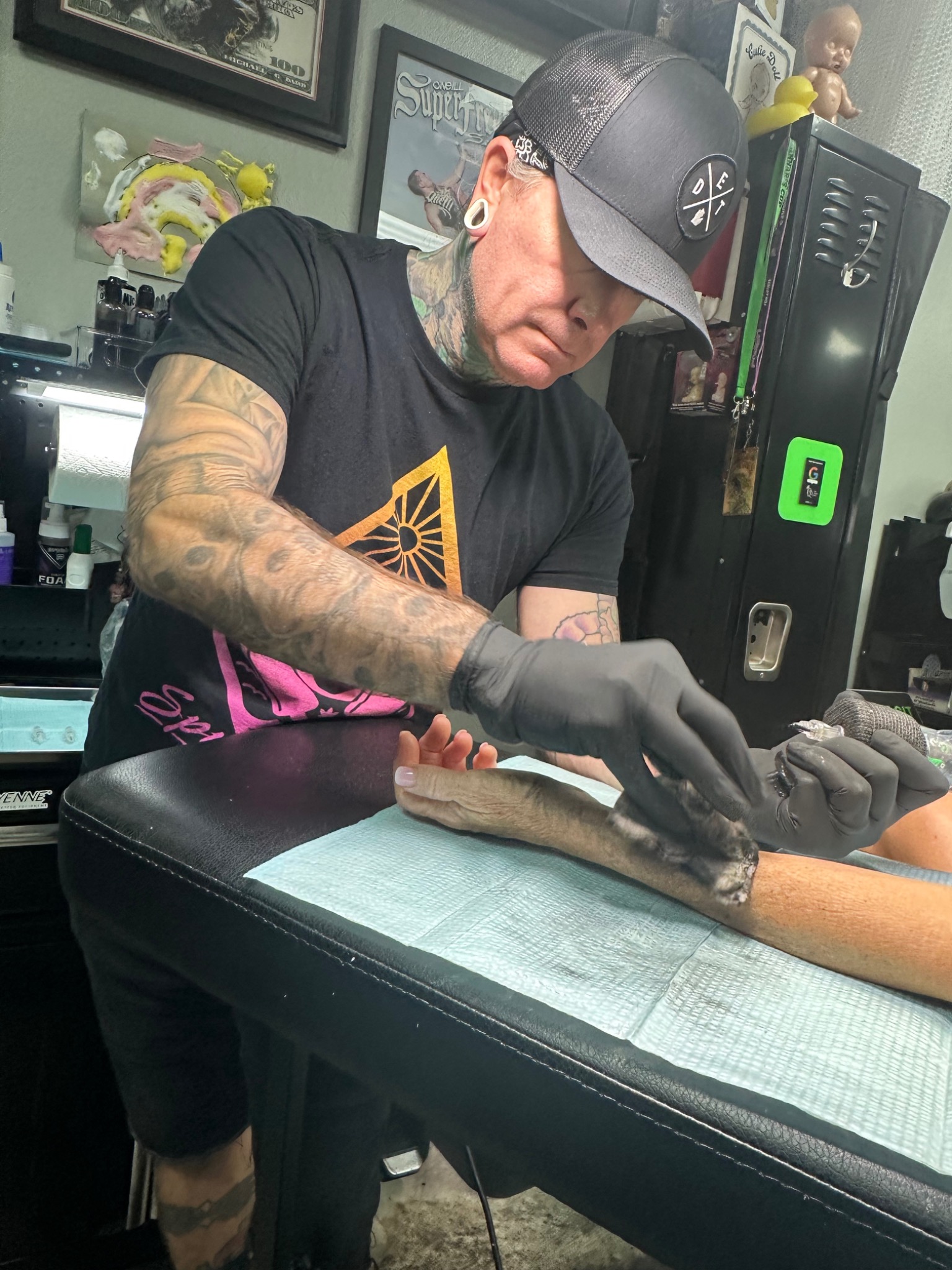 Paulie tattooing a client